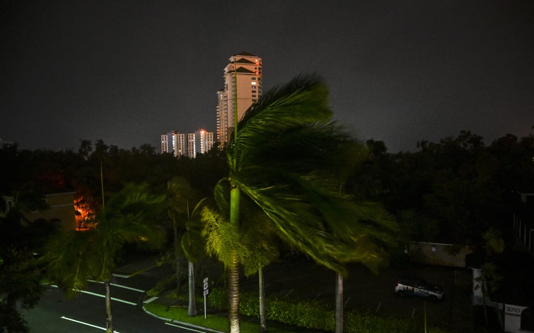 Wind blows as Hurricane Milton makes landfall in Fort Myers, Florida on October 9, 2024. - Milton made landfall in Florida October 9, 2024 as an "extremely dangerous" Category 3 hurricane, packing life-threatening storm surge, extreme winds and flash flooding, the National Hurricane Center (NHC) said. "Data indicate the eye of Hurricane Milton has made landfall near Siesta Key in Sarasota County along the west coast of Florida," the NHC said in an 8:30 pm (0030 GMT Thursday) bulletin. (Photo by CHANDAN KHANNA / AFP)