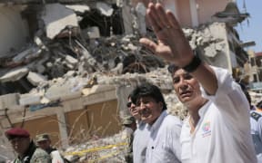 Bolivia's President Evo Morales (centre) and Ecuador's leader Rafael Correa visit a heavily damaged area of Manta, Ecuador.