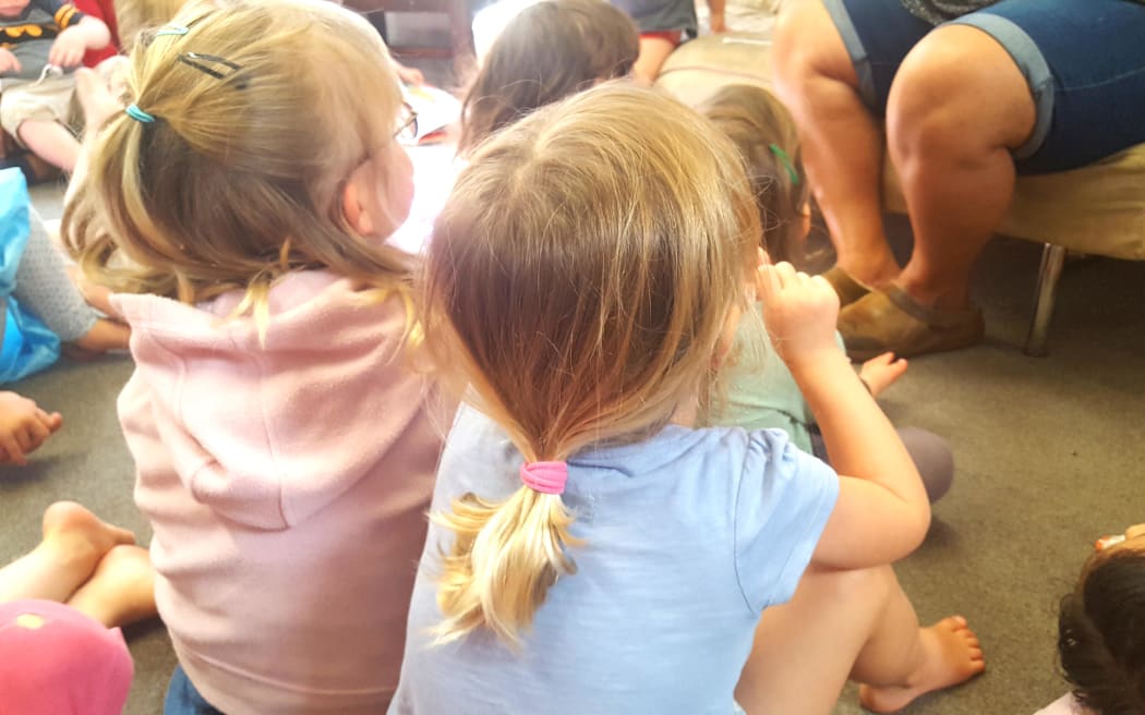 children sit on the mat at an early childhood centre