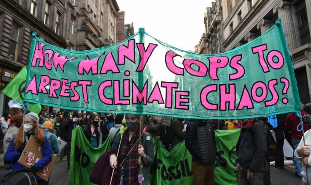 Young climate protesters march through the streets of Glasgow on Friday Nov 5, 2021 to demand action on climate change from leaders and politicians at COP26.