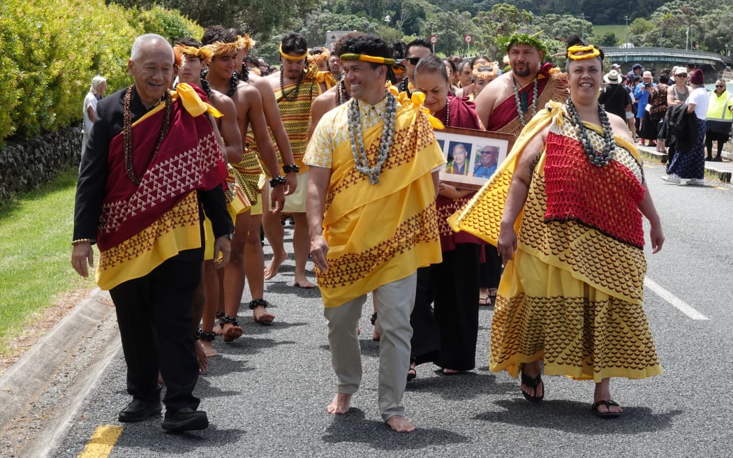 Kamehameha Schools executive cultural director Randie Fong (left) leads the Hawaiian delegation to the beach as the wa’a (waka) approach.