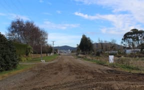 Boniface says her street is dusty in the summer and muddy in the winter.