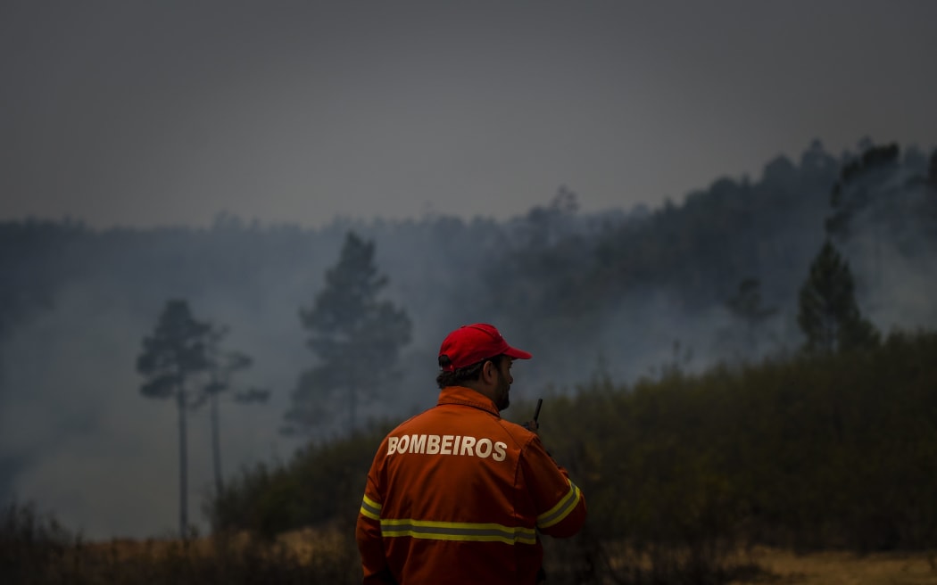 A firefighter monitors a wildfire in Sarnadas, Macao, in central Portugal, on July 21, 2019.