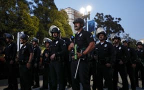 Police officers get into position as pro-Palestinian students and activists demonstrate on the campus of the University of California, Los Angeles (UCLA) in Los Angeles, California, on 1 May, 2024.