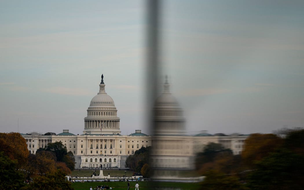 The dome of the US Capitol is reflected in a window as people visit the Washington Monument on November 2.
Mandatory Credit:	Kent Nishimura/Reuters via CNN Newsource