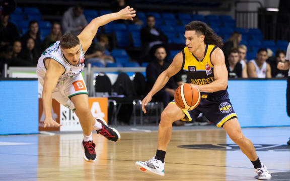 Nuggets guard Jarrod Kenny against Jets forward Hyrum Harris.