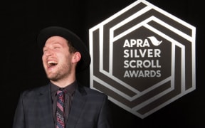Thomas Oliver with his award, the 2016 Apra Silver Scroll.
