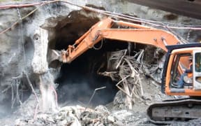 Heavy equipment clearing debris from the Pike River mine portal.