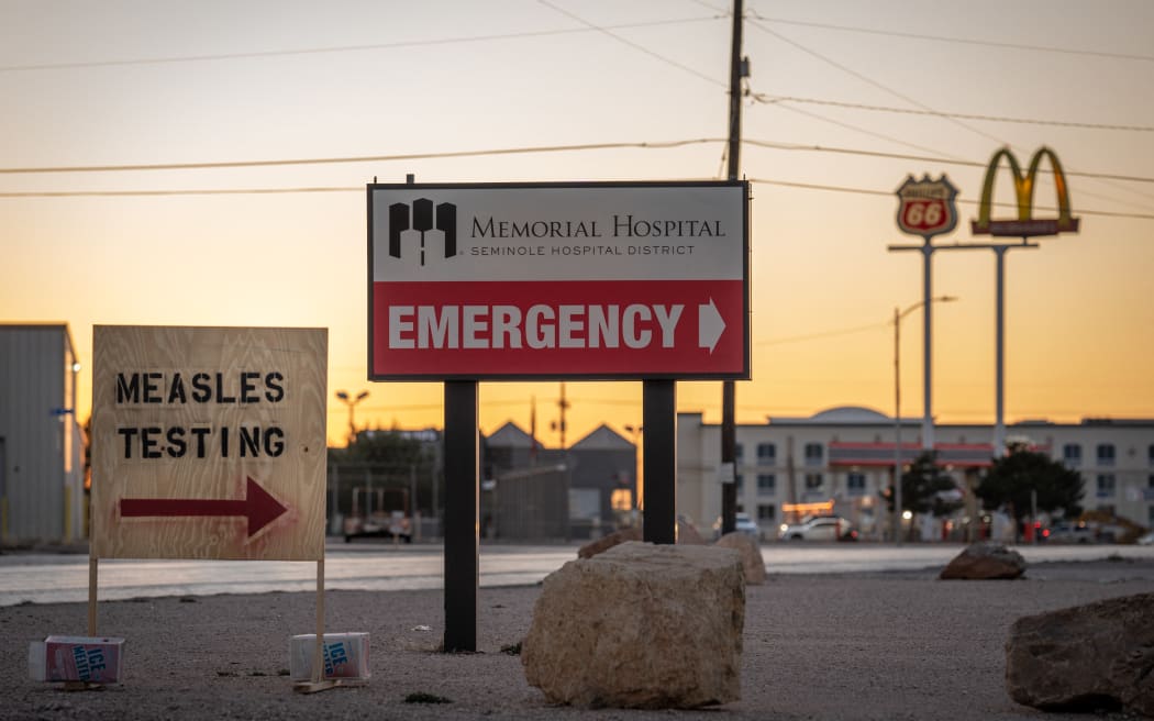 Signs point the way to measles testing in the parking lot of the Seminole Hospital District across from Wigwam Stadium on 27 February, 2025 in Seminole, Texas.