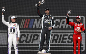 Shane van Gisbergen celebrates on the podium after his win in Mexico City.