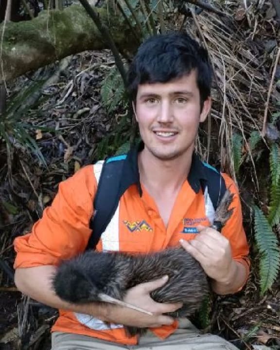 Tom the kiwi's mating partner Jackie being held by site engineer Jack.