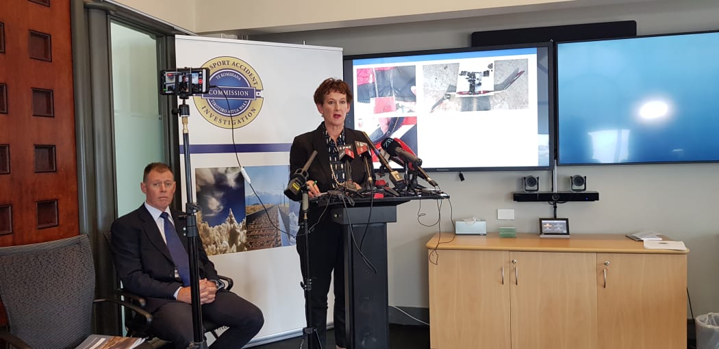 TAIC's chief commissioner Jane Meares and chief investigator Tim Burfoot speak at the presser with the pair of over-trousers pictured in the background.
