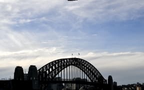 The last Qantas Boeing 747 airliner flies over the Sydney Harbour Bridge during its farewell flight to the US on July 22, 2020.
