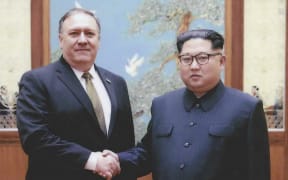 North Korean leader Kim Jong-Un shakes hands with US Secretary of State Mike Pompeo.