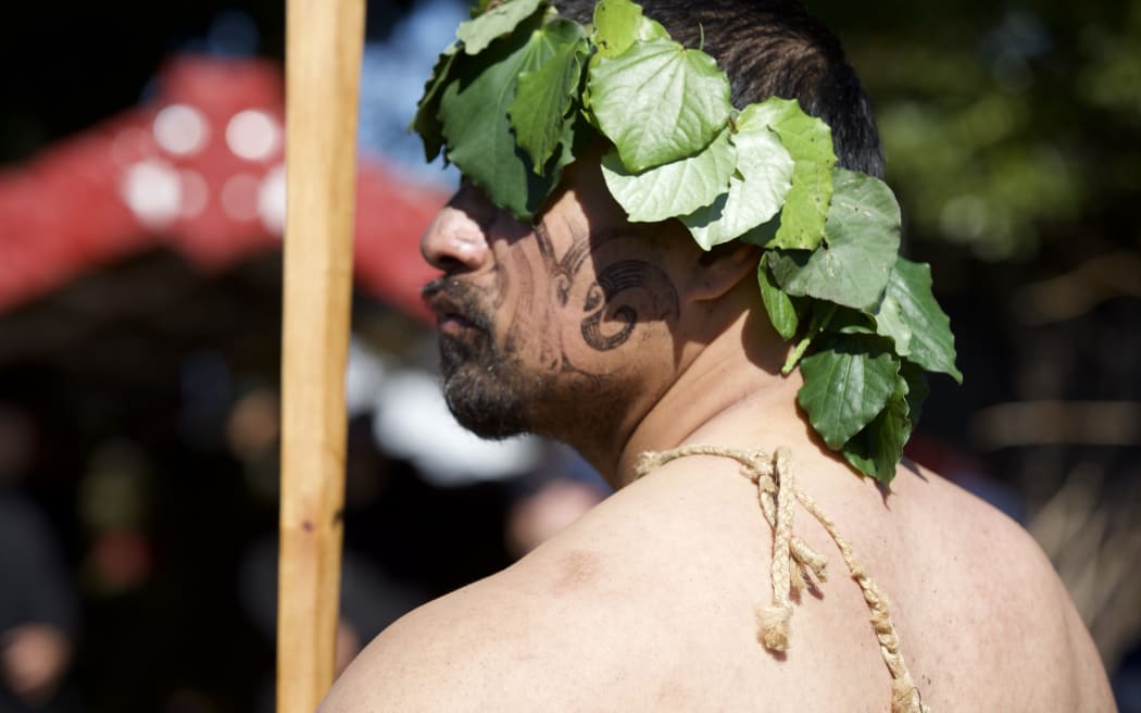 A waka paddler waits to take part in the procession of Kiingi Tuheitia to be buried on Taupiri.