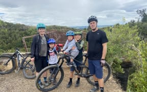 Byron Scott (right) says his children, Mac, George and Miles, are the motivation behind his dream to build a pump track in his community.