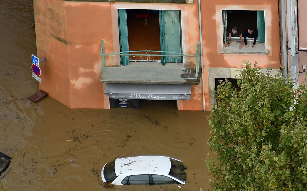 An aerial view taken on October 15, 2018 shows a flooded street in the city of Trèbes