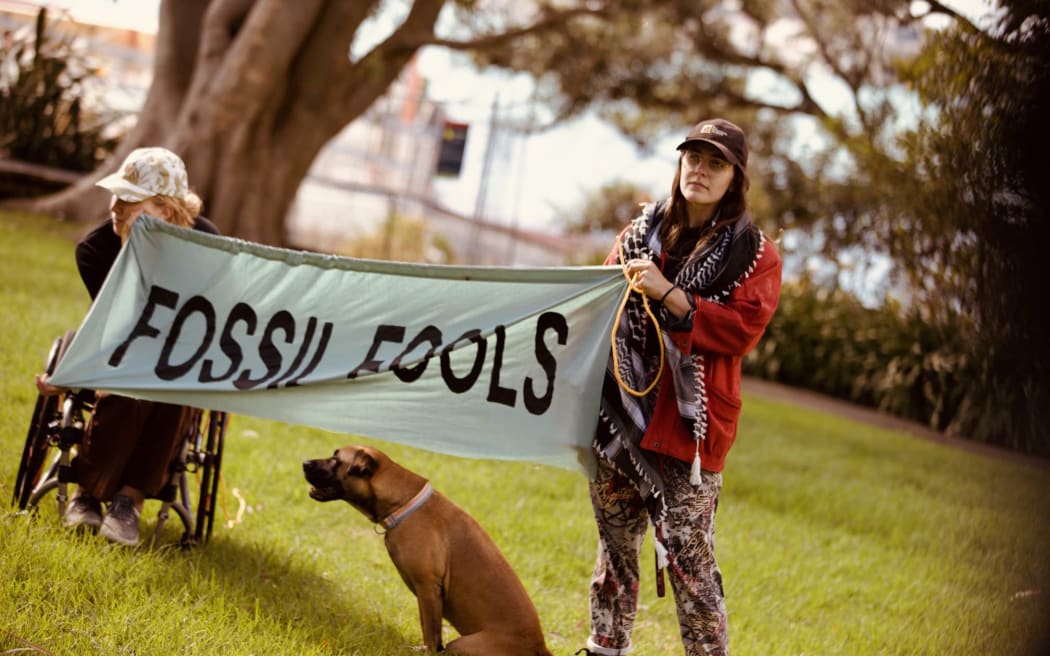 Environmental protesters shouted slogans and held up banners during a press conference by Chris Bishop and Simeon Brown.