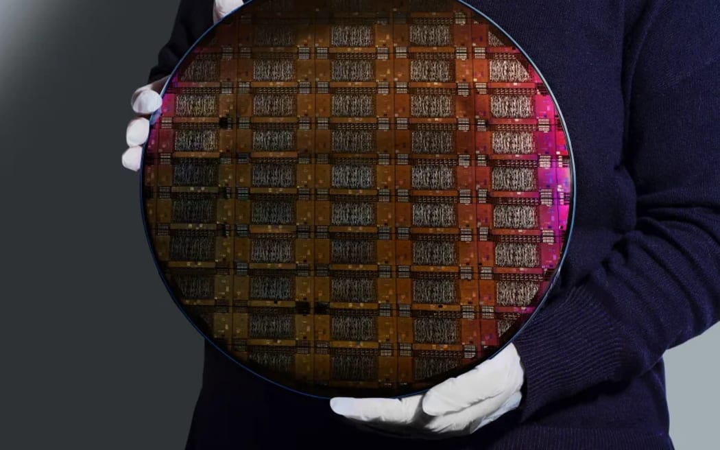 An IBM researcher holds the wafer, or the slice of silicon used to create processors and chips, for the company’s Loon experimental quantum processor. IBM