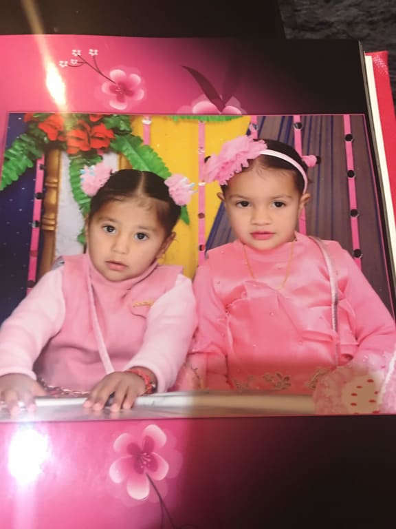 A shot of two young girls, Tarman Kaur and Nimrat Kaur, who are living in India