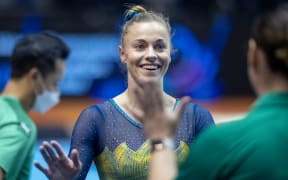 LIVERPOOL, ENGLAND - October 30:  Georgia-Rose Brown of Australia is congratulated by teammates after performing her floor routine during Women's qualifications at the World Gymnastics Championships-Liverpool 2022 at M&S Bank Arena on October 30th 2022 in Liverpool, England. (Photo by Tim Clayton/Corbis via Getty Images)