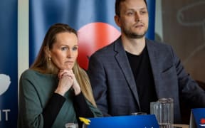 Candidates from the Demokratit party Anna Wangenheim (L) and Jens-Frederik Nielsen address voters attending an all party political meeting at the university in Nuuk, Greenland, on March 6, 2025. Greenland, the autonomous Danish territory, will hold legislative elections on March 11. (Photo by Odd ANDERSEN / AFP)