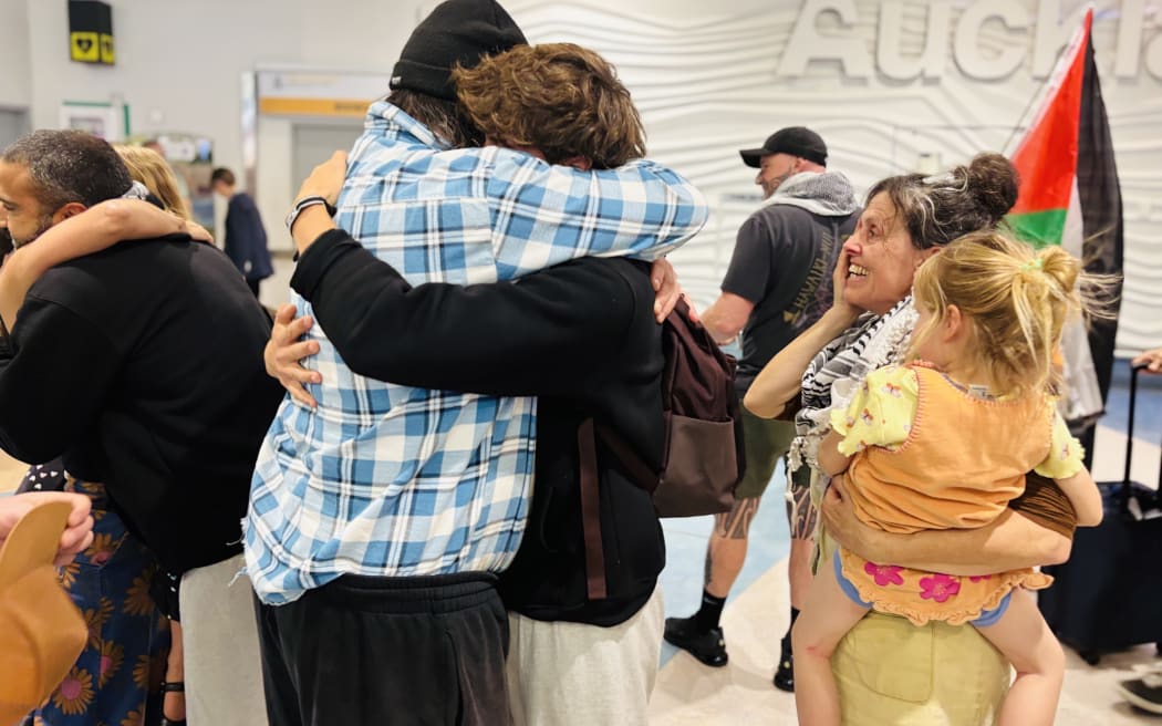 Samuel Leason hugging his father Adi Leason.