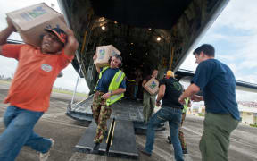 Aid is unloaded from the C-130 Hercules.