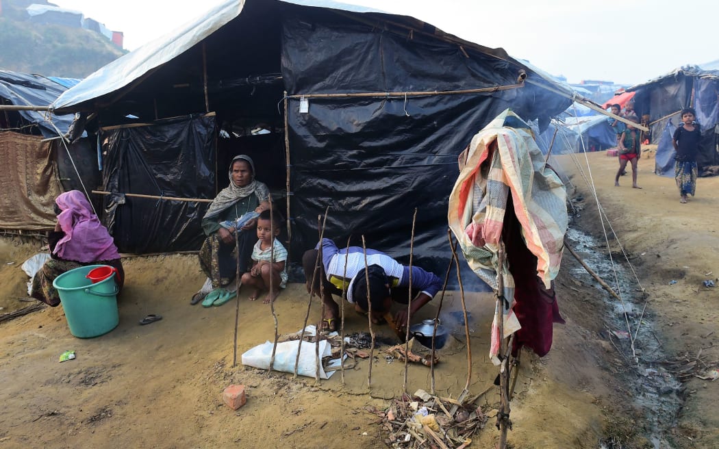 A Rohingya refugee man cooks food in Balukhali refugee camp.