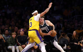 Luka Doncic #77 of the Dallas Mavericks drives to the basket against Anthony Davis #3 of the Los Angeles Lakers during the third quarter at Crypto.com Arena on 17 January 2024 in Los Angeles, California.