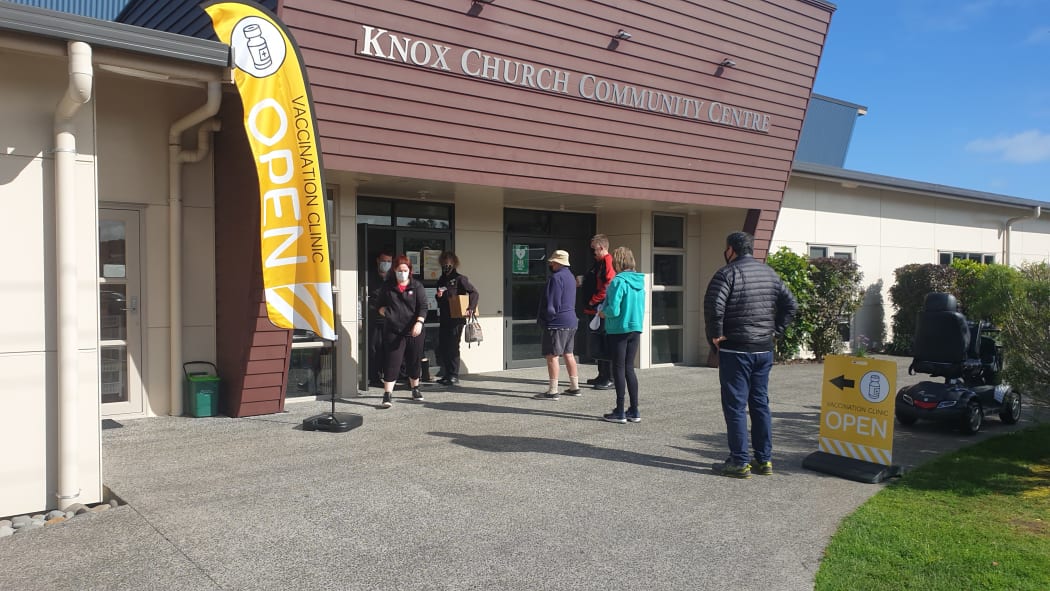 People queue to sign in at Tui Ora's pop up clinic in Waitara.