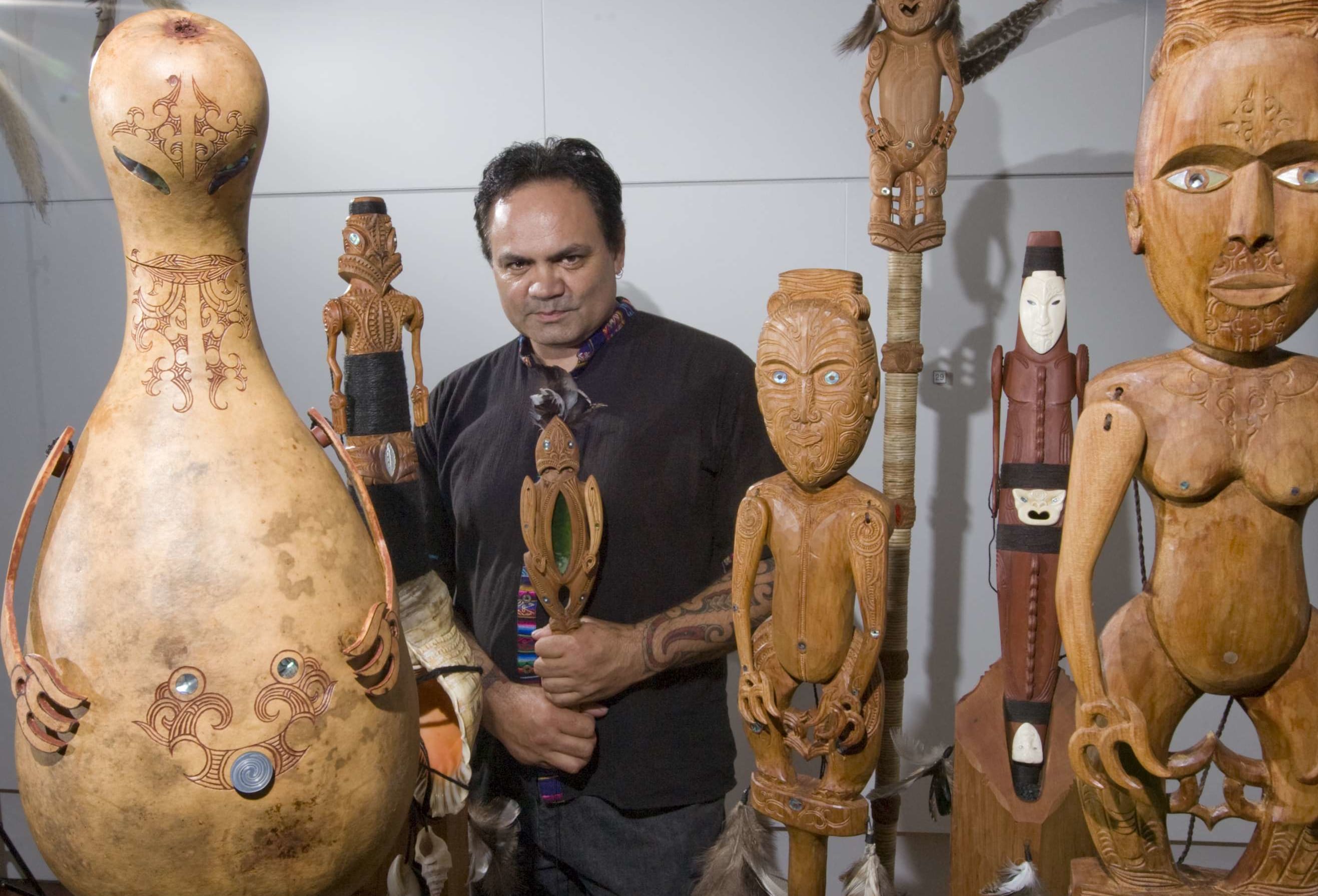 Artist James Webster with seven carved kareatao.