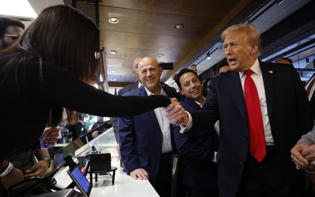 DEARBORN, MICHIGAN - NOVEMBER 01: Republican presidential nominee former President Donald Trump greets an employee during a visit to The Great Commoner cafe on November 01, 2024 in Dearborn, Michigan. With five days until the election, Trump is campaigning on Friday in the battleground states of Michigan and Wisconsin. on November 01, 2024 in Dearborn, Michigan.   Chip Somodevilla/Getty Images/AFP (Photo by CHIP SOMODEVILLA / GETTY IMAGES NORTH AMERICA / Getty Images via AFP)