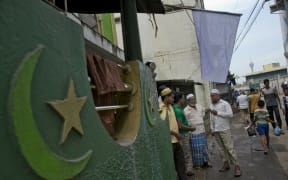 Muslim men gather outside a mosque in Colombo, Sri Lanka, on Friday 26 April.
