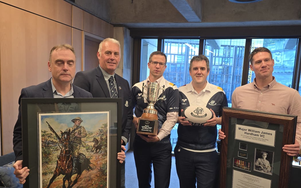 William Harding VC painting and Hardham Cup. (L to R) Mark Brewer, NZ Remembrance Army Trustee; Brent Pritchard, Petone Rugby President; Chris Penk Veterans Minister; Chris Bishop Minister of Sport and Tim Ewing Jarvine NZRA Board Member.