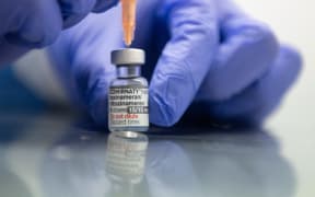 A healthcare worker member draws up a syringe with the BioNTech, Pfizer vaccine adapted to the Omicron-BA.1 variant.