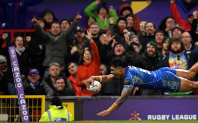 Samoa's Brian To'o dives to score the team's first try during the Rugby League World Cup Men's final between Australia and Samoa.