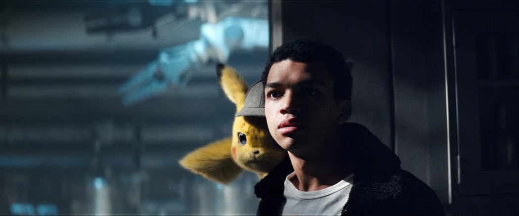 Justice Smith as Tim Goodman with Detective Pikachu (voiced by Ryan Reynolds) in the deerstalker. Check out that film grain!