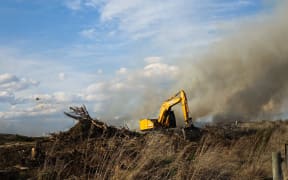A digger takes part in the fight against the Lake Ohau fire
