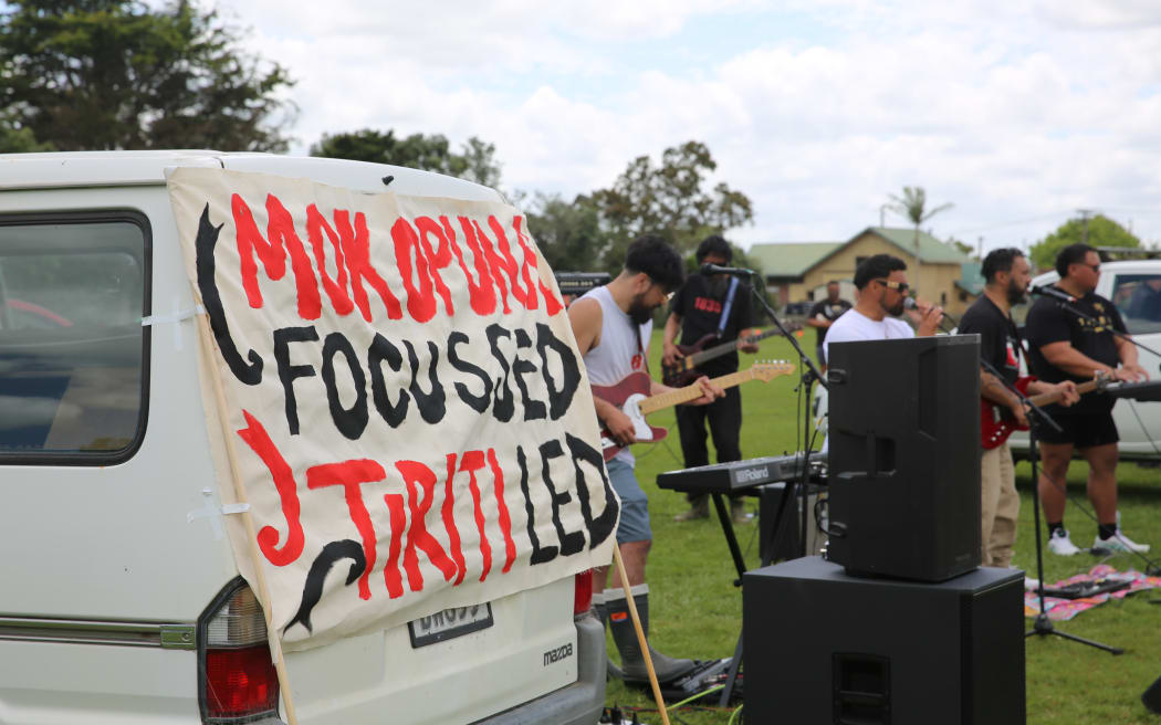 A sign that reads 'Mokopuna focussed, Tiriti led' at the hīkoi in Dargaville.