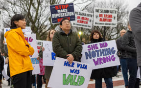 Demonstrators hold signs outside of the Rhode Island State House to protest the deportation of doctor and Brown University assistant professor Rasha Alawieh on March 17.