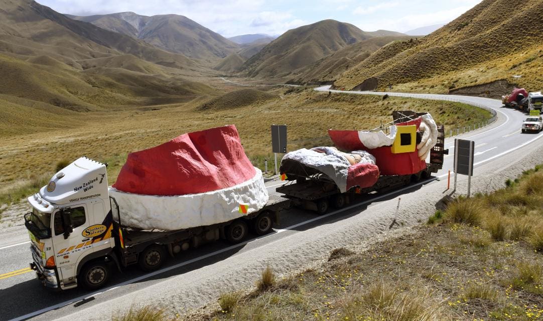 The truck convoy carrying the Auckland Farmers Santa passes the summit of the Lindis Pass on the way to Wanaka yesterday.