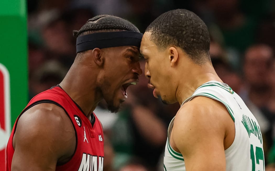Jimmy Butler of the Miami Heat (L) exchanges words with Grant Williams o the Boston Celtics during the fourth quarter in game two of the NBA Eastern Conference Finals.