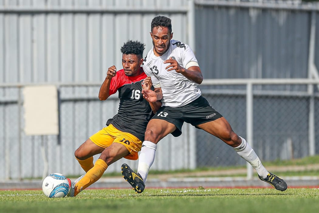 Fiji's Savenaca Baledrokadroka up against Papua New Guinea's Tyran Vapara