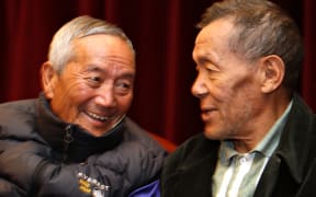 Ang Rita (right) speaks to Nepalese mountaineer Min Bahadur.