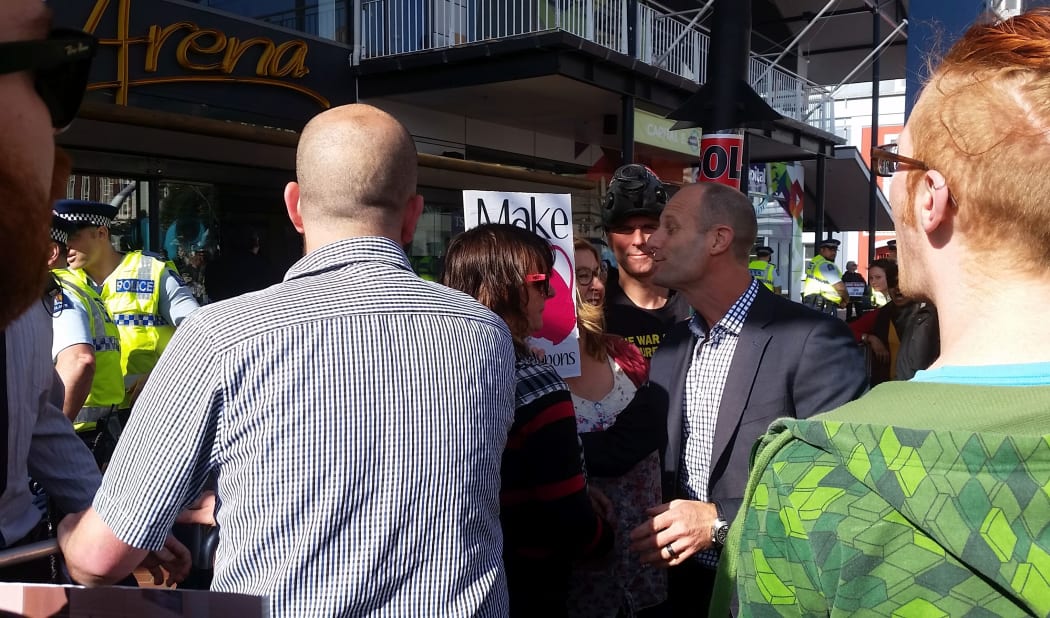 Protestors and an attendee face off in Wellington.