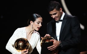 Barcelona's Spanish midfielder Aitana Bonmati (L) and Manchester City's Spanish midfielder Rodri pose with their Ballon d'Or awards in Paris on October 28, 2024.