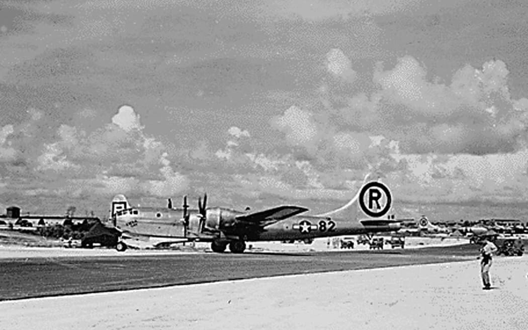 (FILES) This file photo from The National Archives taken 6 August, 1945, shows the B-29 plane "Enola Gay" after landing on Tinian Island from its mission to drop the first Atomic bomb over Hiroshima, Japan. In the middle of the Pacific ocean, an abandoned US airfield once key to dropping the nuclear bomb on Japan -- and nearly lost to history amid encroaching forest -- is being revived. But as the Americans hack away at the jungle overgrowth at Tinian island airfield and other old, World War II-era bases across the region, it won't be with Japan on their mind. Rather, it's Beijing's growing influence in the Pacific that is spurring the recovery of a slew of abandoned runways on the 40 square-mile speck of land that makes up Tinian, part of the US overseas territory of the Northern Mariana Islands. "Rehabilitation of World War II-era airfields has provided Pacific Air Forces (PACAF) a rapidly executable avenue to enhance infrastructure in the region," a spokesperson told AFP. (Photo by THE NATIONAL...