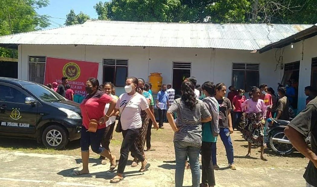 Villagers stand outside a building in Maumere in East Nusa Tenggara on Flores island after a 7.3-magnitude earthquake struck off the coast in eastern Indonesia.