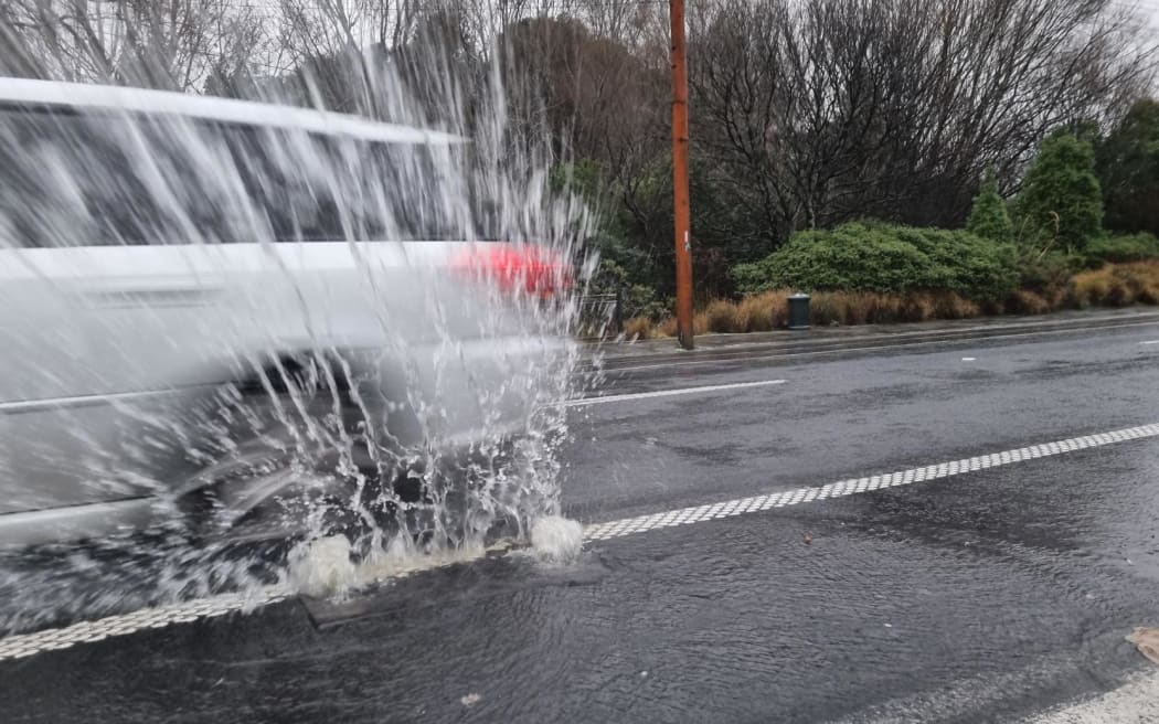 A car in surface flooding on North Road,  in North East Valley, Dunedin.